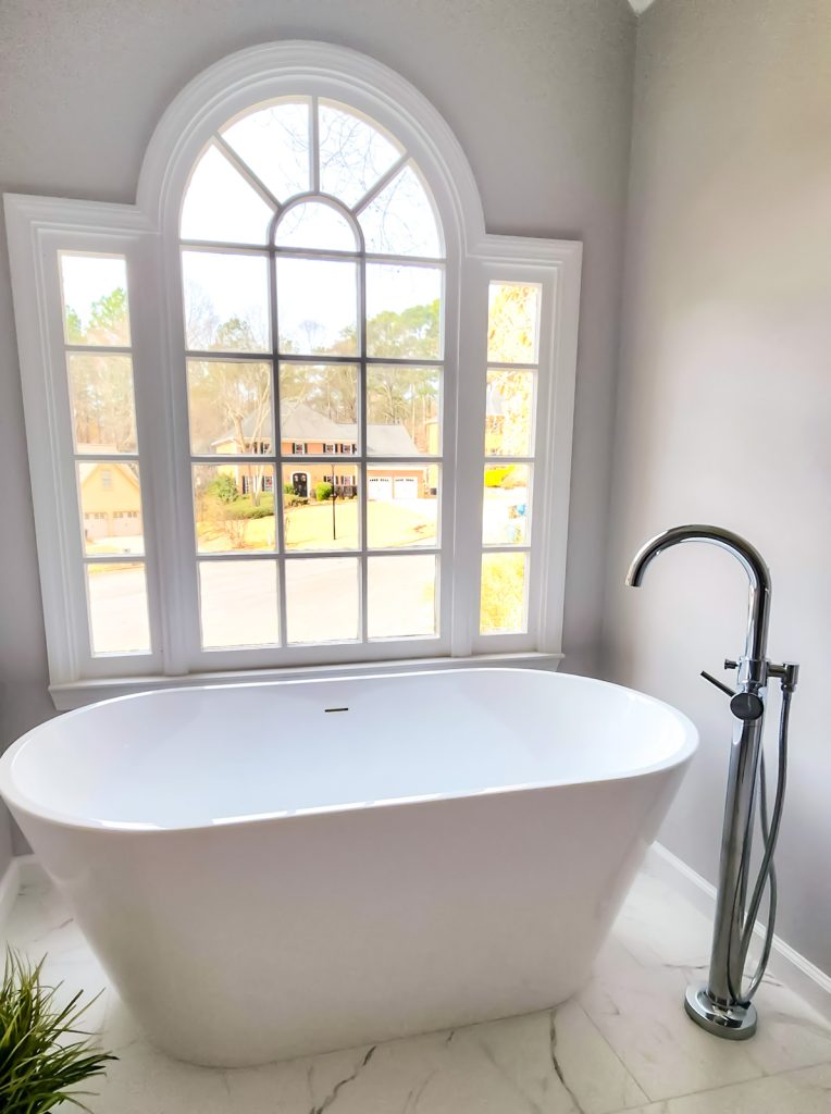 Timeless Master Bath - Elevated Designs: View of white bathtub and elegant window