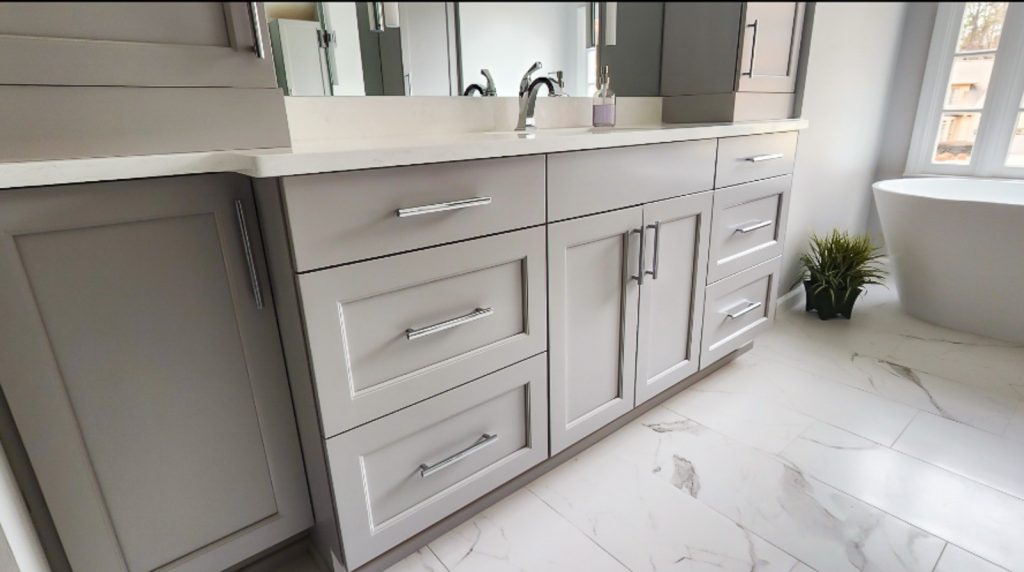 Timeless Master Bath - Elevated Designs: Closeup view of grey cabinets, white counters and marble tile floor