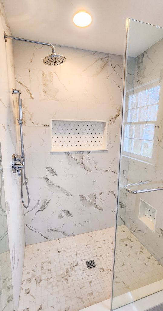 Timeless Master Bath - Elevated Designs: View of full shower with marble tile and storage insert