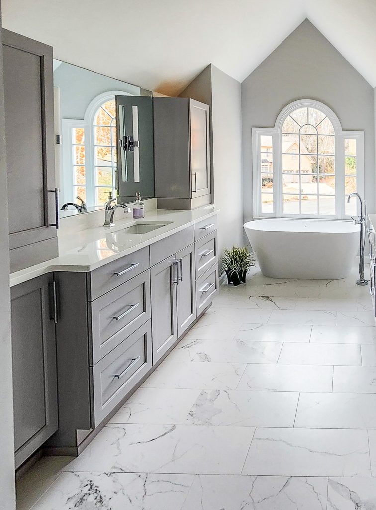 Timeless Master Bath - Elevated Designs: View of vanity area and storage with white tub in background