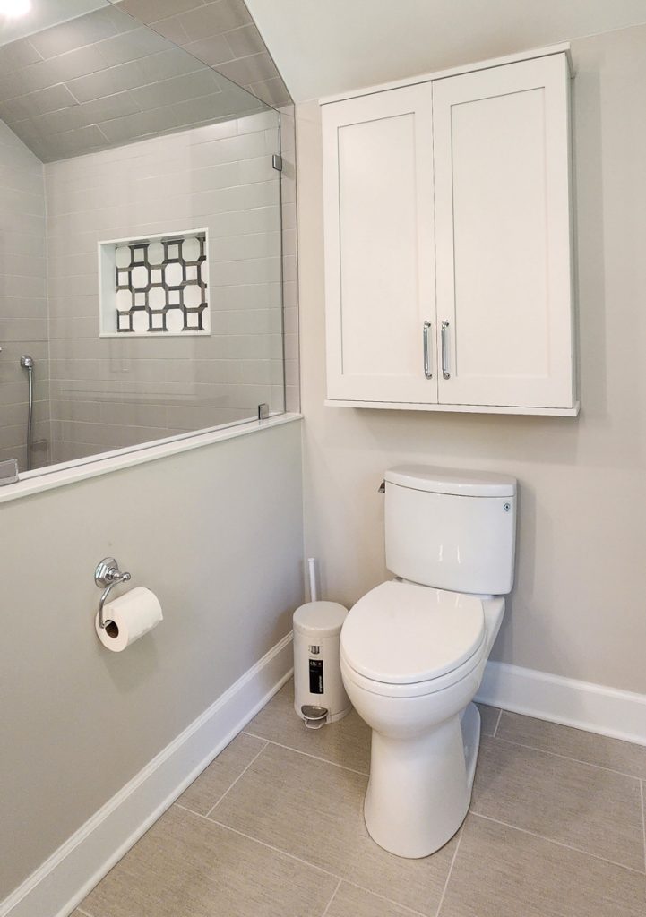 Timeless farmhouse - Elevated Designs: view of toilet area and storage. partial view of in shower