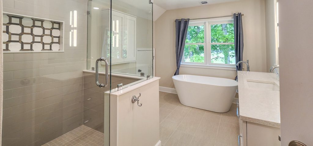 Timeless farmhouse - Elevated Designs: full view of light bathroom with white marble counters and tile floor