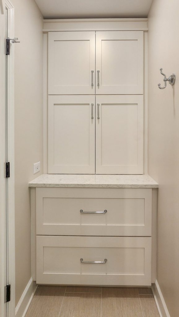 Timeless farmhouse - Elevated Designs: view of storage area with white cabinets