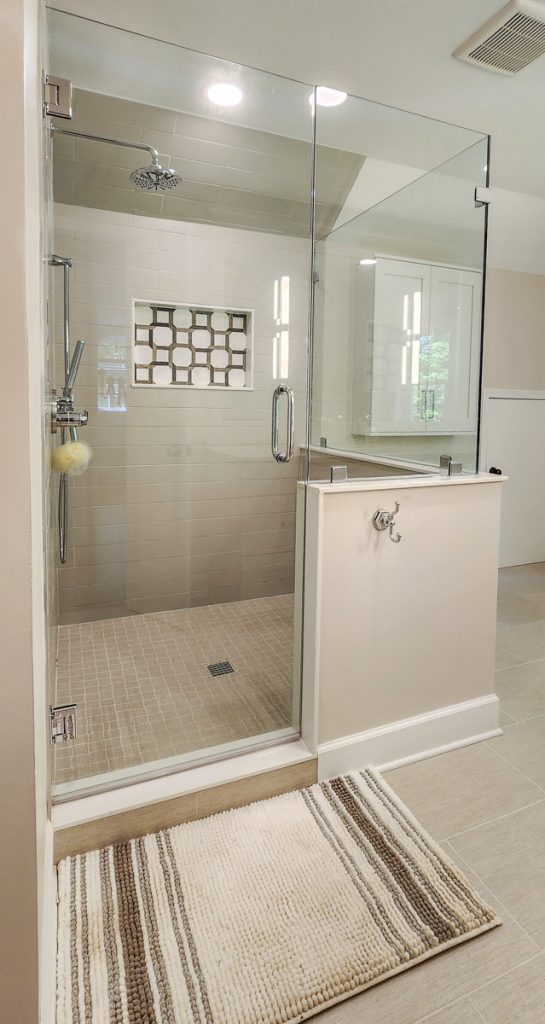 Timeless farmhouse - Elevated Designs: view of full shower area with rug in front