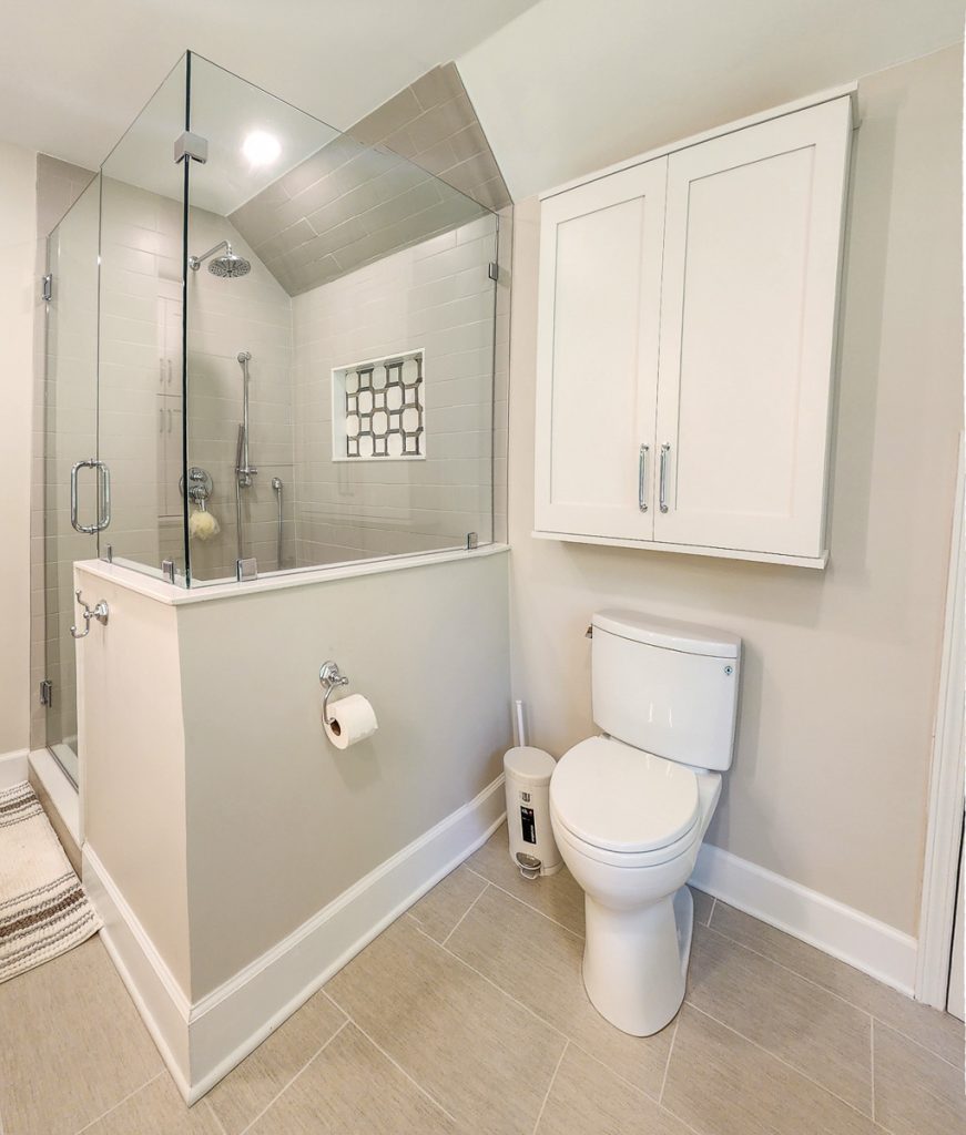 Timeless farmhouse - Elevated Designs: view of toilet area and storage. Full view of in shower