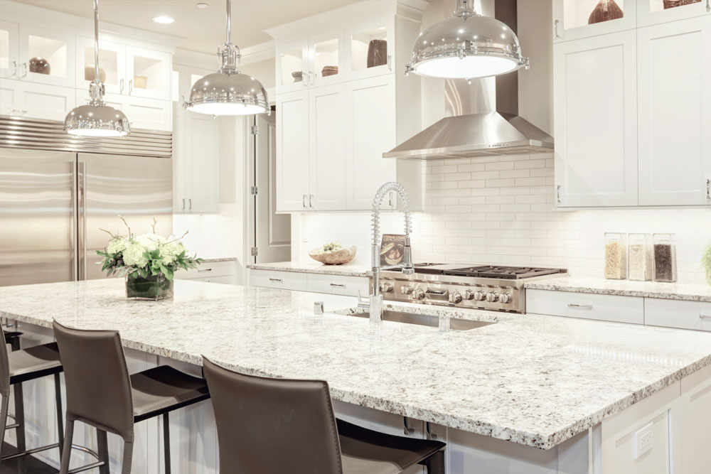 ElevatedDesigns_InnovativeDesign white kitchen with marble countertop and brown high top chairs
